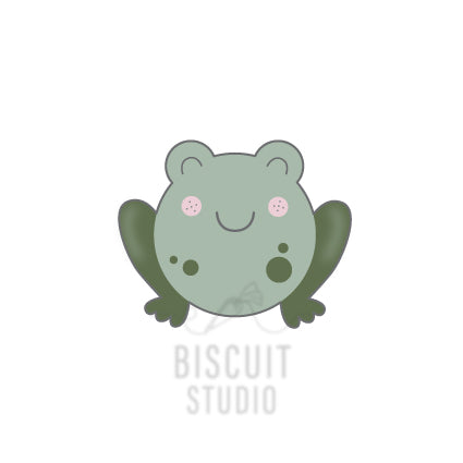 A cartoon illustration of a green frog with a friendly expression, designed as a cookie cutter by Biscuit Studio.