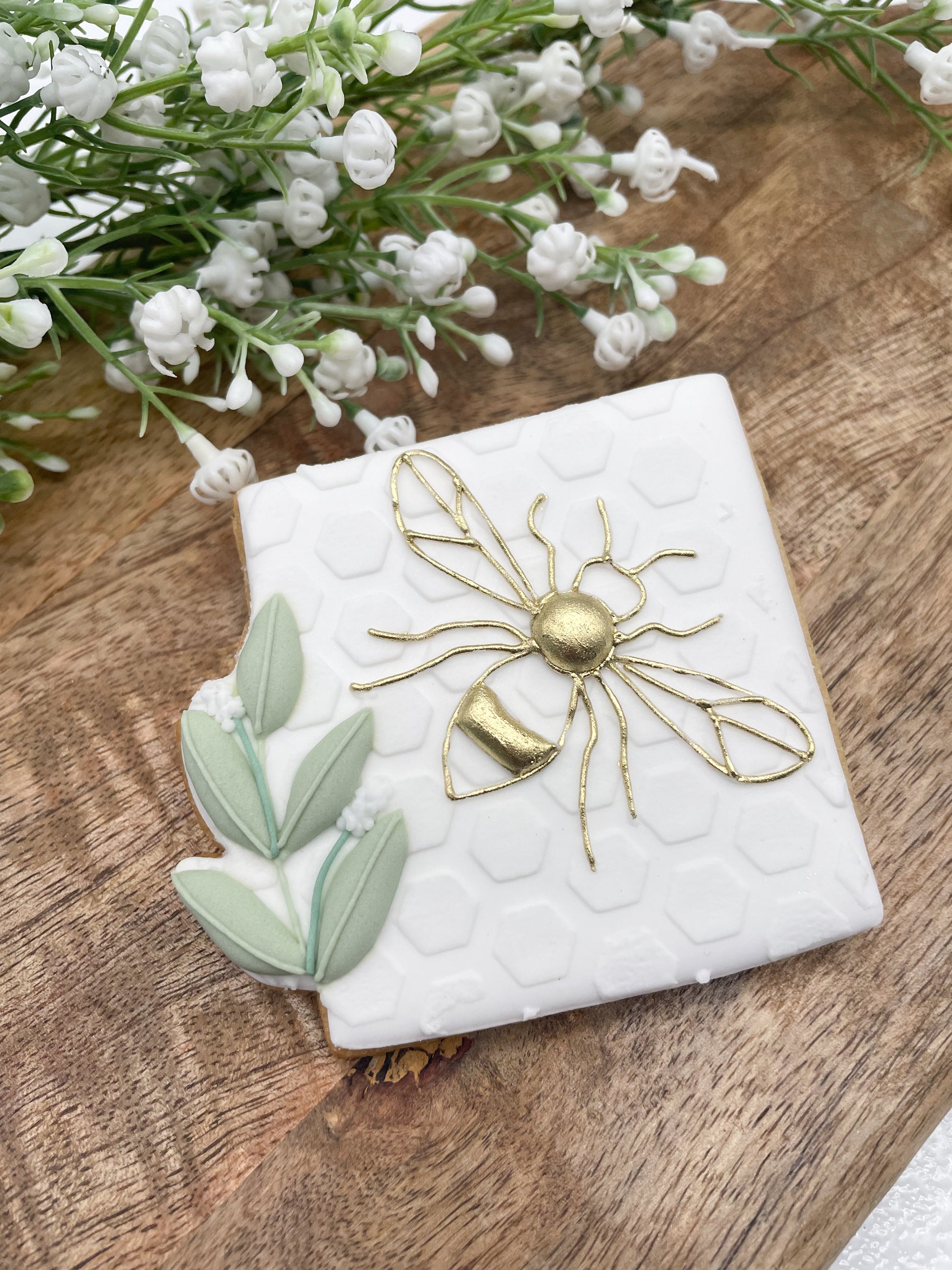 Decorative box with gold bee design by Biscuit Studio.
